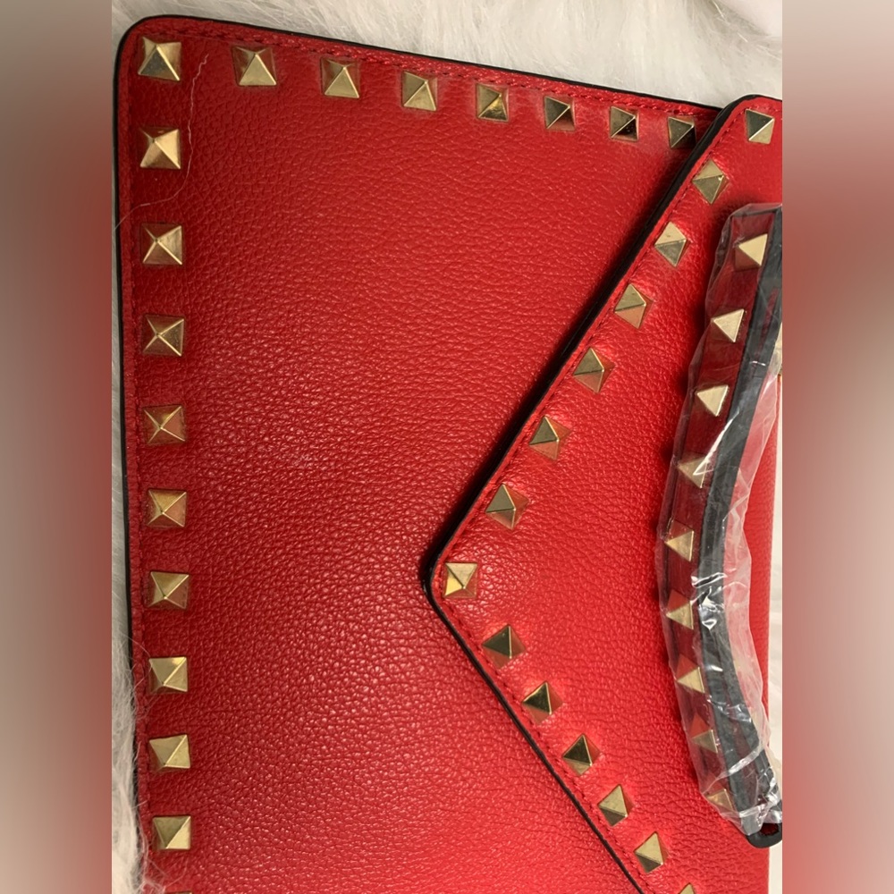 Red envelope style clutch bag with gold studs